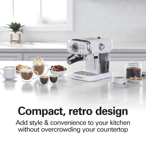 Kickstart Your Morning Grind With This Retro White Espresso Machine on a countertop with coffee cups, pastries, and fruit.