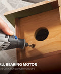 Person using Corded Rotary Tool Kit With 24 Accessories And 1 Attachment Six Variable Speeds For Precise Cutting Sanding Grinding Polishing Drilling Engraving Perfect For Pro Makers And DIYers on a wooden project