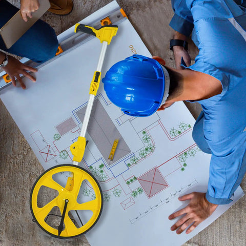 Workhorse Digital Measuring Wheel With Backlit Display beside engineers planning on a construction map with blueprint