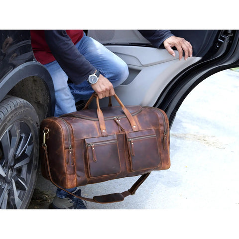 Man lifting 32 Inch Vintage Duffel Bag With Old School Look And Modern Touch Handmade Full Grain Buffalo Leather Carry On Fits Under Seat