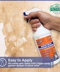Hand holding 32oz World's Best Wallpaper Stripper And Sticky Paste Remover, Citrus Scent, easy peel, no residue cleanup.