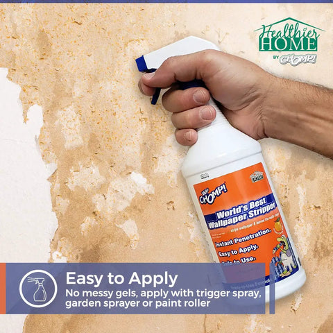 Hand holding 32oz World's Best Wallpaper Stripper And Sticky Paste Remover, Citrus Scent, easy peel, no residue cleanup.