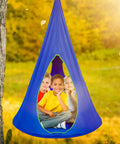 Kids Nest Swing Hammock Chair With Adjustable Rope Indoor Outdoor 40 Inch Blue Pod Swing filled with three kids in a park.