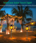 Outdoor Solar Torch Lights With Flickering Flame illuminating a beachside canopy, creating a welcoming atmosphere under palm trees.