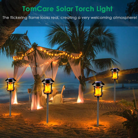 Outdoor Solar Torch Lights With Flickering Flame illuminating a beachside canopy, creating a welcoming atmosphere under palm trees.