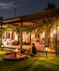 Night scene with Solar Pathway Lights 4 Pack Outdoor IP65 Waterproof Garden Lights illuminating yard near patio with fire pit