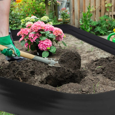 Gardener using spade with 8 Inch Tall 33 Ft Garden Landscape Edging Kit Black Plastic Border for Lawn and Flower Beds