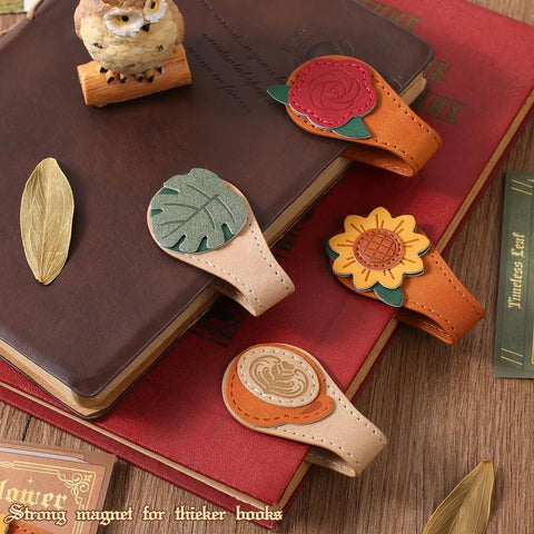 4 Piece Vintage Magnetic Leather Bookmarks With Retro PU Clip, Legit Game Changer For Reading Stacks shown atop books.