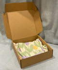 Heavy Duty 20 Pack Of 10X10X3 Inch Brown Corrugated Cardboard Shipping Boxes With Smooth Finish Edges for mailing with a cloth inside.