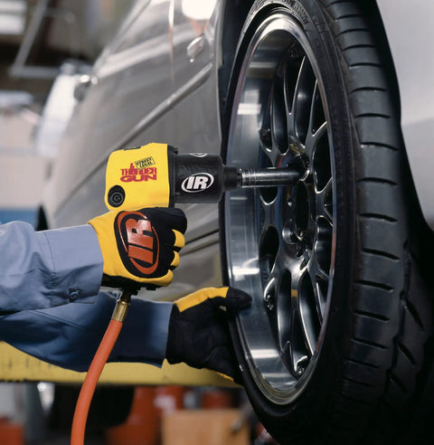 Precision Crafted Half Inch Drive Pneumatic Impact Wrench Producing Six Hundred Twenty Five Foot Pounds Of Torque At Ten Thousand Rpm For Pit Crew Hustle And Grease Monkey Daily Runs in use on a car wheel.