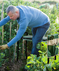 Heavy Duty Garden Kneeler and Seat with Large Four Pocket Tool Bag in use while gardening, showing sturdy frame and tool storage.
