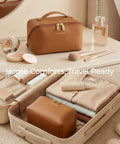 Go To Large Makeup Bag Travel Cosmetic Organizer In PU Leather Flat Open Toiletry Case For Women Wide Opening Pouch Classic Brown Finish on vanity and suitcase