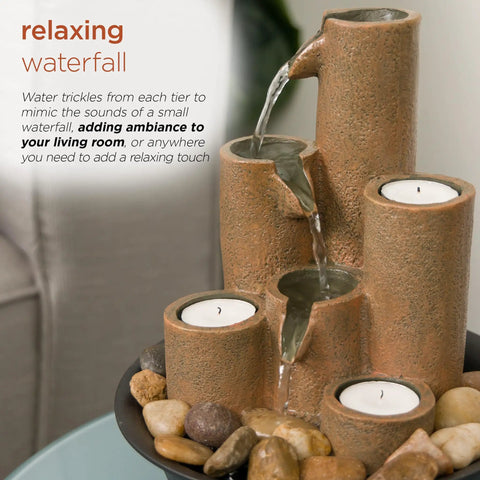 Indoor Tabletop Tiered Water Fountain With 3 Candles, 11 Inch Brown, placed on a table surrounded by rocks, creating a cozy ambiance