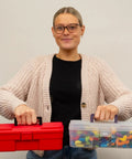 Person holding a red toolbox and 12-Inch ProBox Plastic Storage Toolbox For Art Supplies And Crafts, showing clear organizer case with rounded edges.