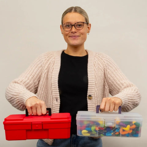Person holding a red toolbox and 12-Inch ProBox Plastic Storage Toolbox For Art Supplies And Crafts, showing clear organizer case with rounded edges.