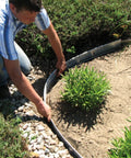 Person installing Aluminum Landscape Edging Kit For Lawn And Garden 8 Edging Pieces With Spikes 48 Feet Total Black Rustproof