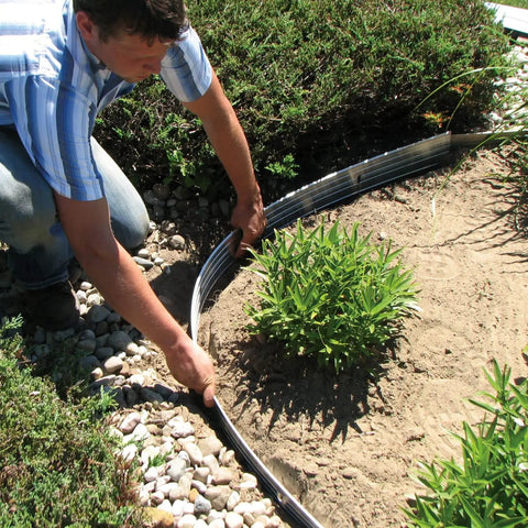 Person installing Aluminum Landscape Edging Kit For Lawn And Garden 8 Edging Pieces With Spikes 48 Feet Total Black Rustproof