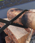 Heavy Duty Collapsible Firewood Tongs 28 Inch Solid Manganese Steel With Serrated Scissor Jaws gripping a log.