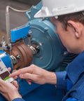 Technician using Pro Grade Shaft Alignment Tool TKSA 11 For Precise Drive System Alignment with smartphone app support on machinery.