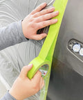 Applying Pro Grade Performance Masking Tape 233 Plus, 24 mm Wide By 55 M Long, Flexible Backing on car for precise auto lines
