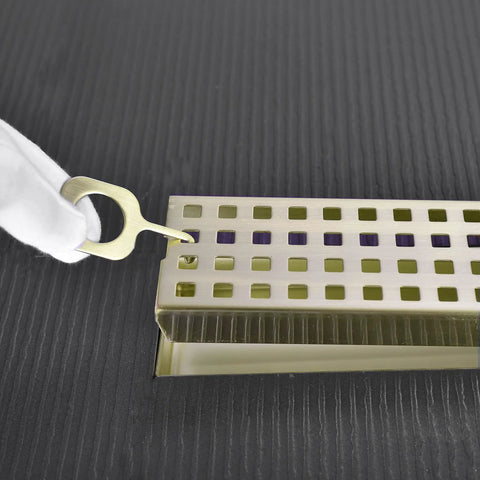 Close-up of 24 Inch Linear Shower Drain With Removable Cover Grid And Hair Catcher Brushed Gold Stainless Steel Trench Floor Drain With Adjustable Leveling Feet Easy To Clean Low Maintenance Perfect For Modern Bathrooms.
