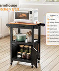 Slick Rolling Kitchen Cart With Microwave Stand And Storage Cabinet And Drawer, Compact Coffee Cart With Side Hooks And Towel Rod, Smooth Lockable Swivel Wheels, Built Tough, Black Finish, featuring microwave and pots.