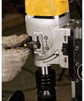 DEWALT magnetic drill press side close-up showing adjustment lever, gray housing, and chuck