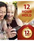 Two women smiling while looking at a camera, with text displaying '12 Hour Hold', symbolizing long-lasting denture adhesive.