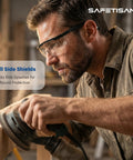 Man wearing Tough As Nails Clear Safety Glasses Heavy Duty Bulk Pack featuring adjustable temples and side shields while sanding wood.