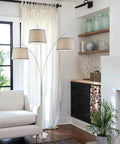 Arc Floor Lamp With 3 Lights, Standing 79 Inches Tall, Modern Brushed Nickel Finish With Gray Burlap Shades, in a living room