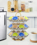 Heavy Duty Metal K Cup Pod Organizer Carousel For Home Kitchen Counter Coffee Station, Holds 27 K Cups, Compatible With K Cup Pods And Dolce Gusto, Gold Finish, Sturdy, Rust-Resistant Design on kitchen counter next to coffeemaker.