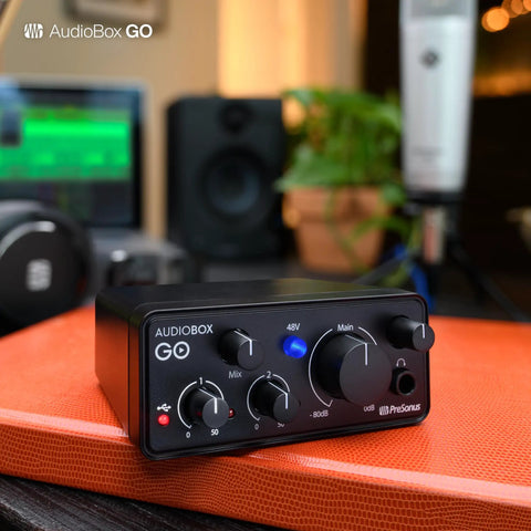 Ultra-Compact USB-C Audio Interface For Home And On-The-Go Music Production with Studio One Prime DAW on orange surface
