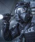 Officer holding ProTac HL 5-X 3500 Lumen Multi Fuel Tactical Flashlight With Rechargeable Batteries And USB in a dark setting.