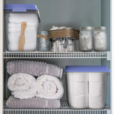 Kick Ass 32 Quart Clear Plastic Stackable Storage Bins With Blue Latching Lids organizing towels on shelf in bathroom storage.