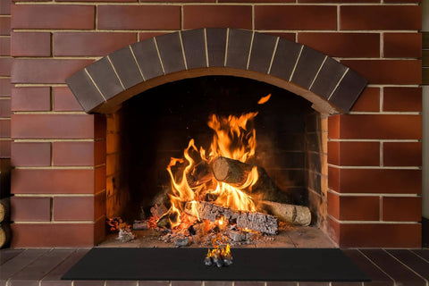 9x12 Inch Heavy Duty Heat Shield Barrier Blanket With Reflective Insulation Carbon Felt in front of fireplace with flames