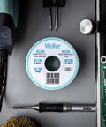 Spool of Weller solder wire with tools, not Sn60Pb40 Solder Wire With 2.2% Flux, 0.3 mm Diameter, 100 g Spool, in workspace setup