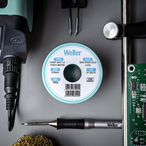 Spool of Weller solder wire with tools, not Sn60Pb40 Solder Wire With 2.2% Flux, 0.3 mm Diameter, 100 g Spool, in workspace setup