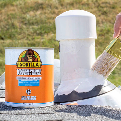 Person applying Patch And Seal Liquid Rubber Waterproof Sealant White 32 Ounce to a vent on a roof with a brush.