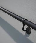 Rock Solid Steel Staircase Handrail Six And A Half Feet Long No Sweat Wall Mount Indoor Safety Railing With Grippy Matte Black Coating angled view on wall.