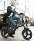 Peak 500W Step Through Fat Tire Electric Bike With 48V Removable Battery For Easy Recharges And Long Rides Up To 40 Miles 7 Speed LCD Display Sixteen Inch By Three Inch Fat Tire For City Cruisin And Trail Ridin., man riding black step-through fat tire electric bike on city street