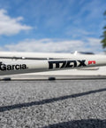 Close-up of Max Pro Spinning Rod And Reel Combo 6 Foot 10 Inch, Size 2500 Reel, resting on outdoor surface