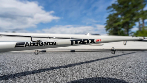 Close-up of Max Pro Spinning Rod And Reel Combo 6 Foot 10 Inch, Size 2500 Reel, resting on outdoor surface