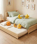 Solid Pine Twin Bed Frame With Pull Out Trundle, featuring plush toys and natural wood finish in a cozy room.