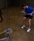 User performing curls with Straight Up Heavy Duty Aluminum Curl Bar Attachment Compatible With Cable Machines in home gym.