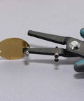 1.8mm Metal Hole Punch With Gauge Guard for clean indent-free holes in brass sheet, shown making a hole for 1.3mm rivets and cold connections.
