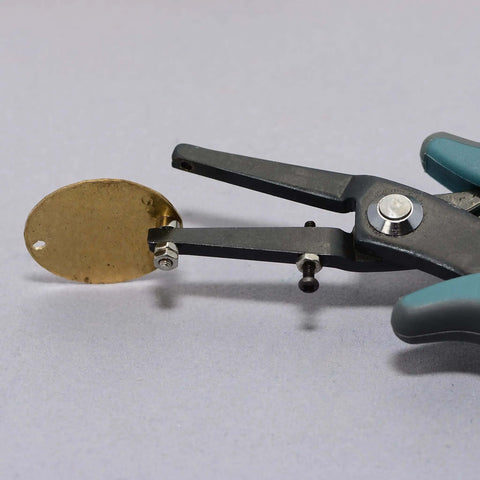 1.8mm Metal Hole Punch With Gauge Guard for clean indent-free holes in brass sheet, shown making a hole for 1.3mm rivets and cold connections.