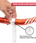 Person measuring 31.8mm clamp diameter on a Full On Mountain Bike Handlebar, 31.8mm Clamp, 785mm Wide, 30mm Rise Beefy Alloy Riser Bar