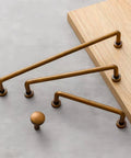 Vintage Antique Brass Drawer Pulls 10 Piece Set For Cabinets And Vanities displayed on wooden surface