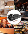 Electric Espresso Grounds Collection Box With Automatic Portafilter Cleaner For 58mm Filters in a modern café setting.