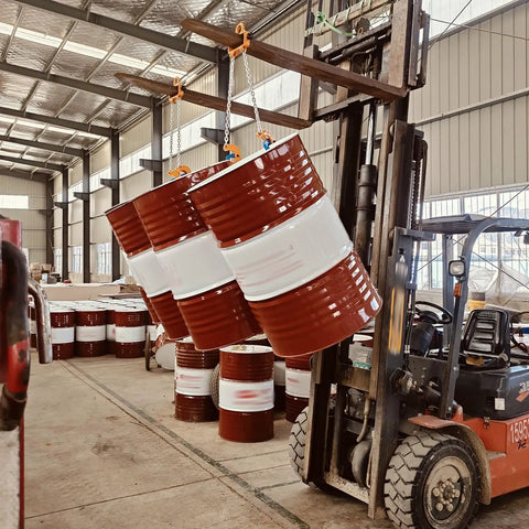 Heavy Duty Drum Lifter Clamp For Forklifts And Job Site Cranes Featuring Carbon Steel Chain lifting three barrels in warehouse.